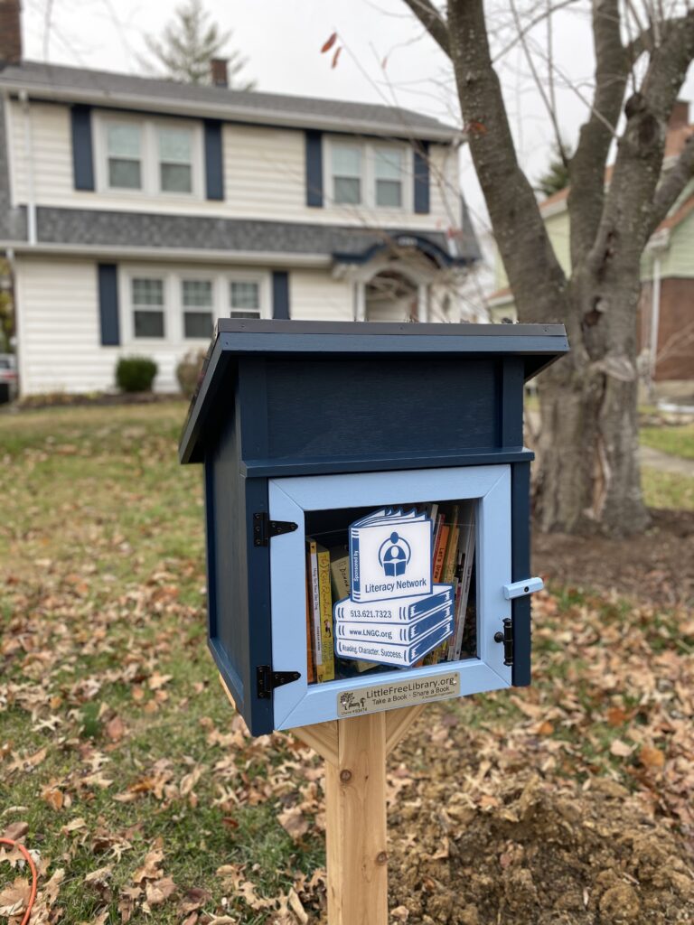 Photo of a Little Free Library in the front yard of a house