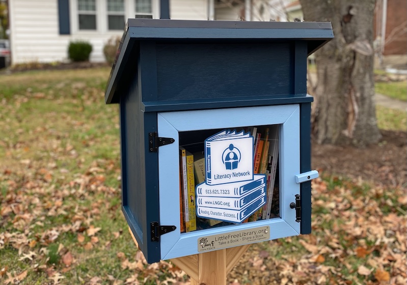 Thumbnail image of Little Free Library in front of a house