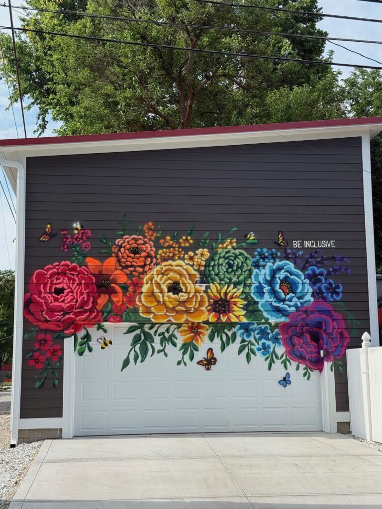 A garage with a colorful flower mural painted on it.