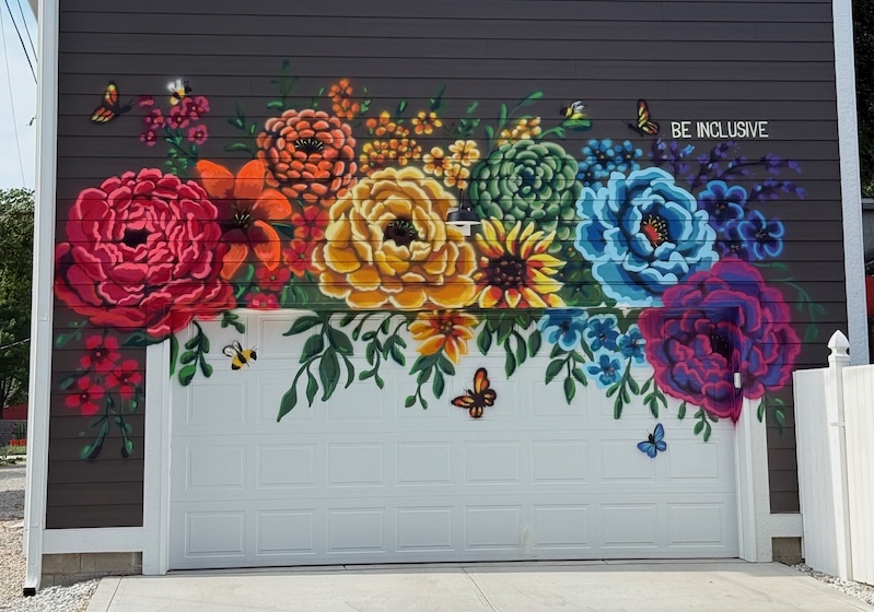 A garage with a colorful flower mural painted on it.